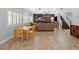 Open living area with fireplace, staircase, and dining table at 6136 Stanton Summit Dr, North Las Vegas, NV 89081
