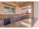Elegant outdoor kitchen featuring stone accents, granite countertops, and a built-in grill at 6136 Stanton Summit Dr, North Las Vegas, NV 89081
