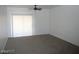 An empty living room featuring sliding glass doors to the rear of the property at 833 Aspen Peak Loop # 2614, Henderson, NV 89011