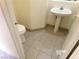 Powder room featuring a pedestal sink and tile flooring at 8379 Drop Camp St, Las Vegas, NV 89123