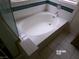 Corner bathtub with tile surround and shower to the left at 8379 Drop Camp St, Las Vegas, NV 89123