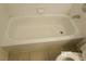 A white bathtub is shown with white tiled walls with a dark accent row at 8379 Drop Camp St, Las Vegas, NV 89123