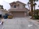 Two-story home featuring a tile roof, two car garage, and desert landscaping at 8379 Drop Camp St, Las Vegas, NV 89123