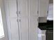 Kitchen pantry boasts ample storage with white cabinets and sleek black hardware at 8379 Drop Camp St, Las Vegas, NV 89123