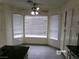 Bright kitchen nook features tile flooring, large windows, and a ceiling fan at 8379 Drop Camp St, Las Vegas, NV 89123