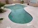 Inviting kidney-shaped pool surrounded by a concrete patio and desert landscaping at 8379 Drop Camp St, Las Vegas, NV 89123