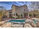 Gorgeous backyard with a custom pool, spa, and covered patio, perfect for outdoor entertaining and relaxation at 8953 Belconte Ln, Henderson, NV 89074