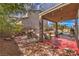 Inviting backyard featuring a covered patio, rock accents, and a glimpse of the sparkling pool at 8953 Belconte Ln, Henderson, NV 89074
