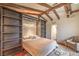 Charming bedroom featuring exposed wood beams, a built-in bookshelf, and a cozy seating area at 8953 Belconte Ln, Henderson, NV 89074