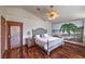 Comfortable bedroom featuring hardwood floors, a beach-themed wall mural, and neutral decor at 8953 Belconte Ln, Henderson, NV 89074