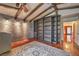 Spacious bedroom boasting exposed beams, built-in shelving, and a rustic brick accent wall at 8953 Belconte Ln, Henderson, NV 89074