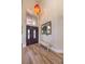 Bright foyer featuring wood floors, a bench seat, and an elegant front door with decorative glass at 8953 Belconte Ln, Henderson, NV 89074