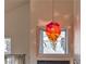 Foyer featuring a unique modern chandelier over the entry, with a view of the front door at 8953 Belconte Ln, Henderson, NV 89074