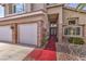 Elegant front entrance with stone accents, a red walkway, and a charming hanging light fixture at 8953 Belconte Ln, Henderson, NV 89074