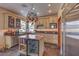 Kitchen features an island with a wine cooler, stainless appliances, and granite counters at 8953 Belconte Ln, Henderson, NV 89074