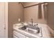 Simple laundry area with sink, white cabinetry, and neutral walls, perfect for everyday chores at 8953 Belconte Ln, Henderson, NV 89074