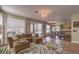 Open-concept living area with a sectional sofa, opening to the kitchen and backyard at 8953 Belconte Ln, Henderson, NV 89074