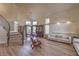 Open-concept living area featuring a staircase, wood floors, and large windows for natural light at 8953 Belconte Ln, Henderson, NV 89074