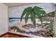 Detailed mural of a beach scene with palm trees, ocean waves, and sandy dunes at 8953 Belconte Ln, Henderson, NV 89074