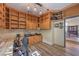 Spacious office with custom built-in shelving, desk space, and wood-look tile flooring at 8953 Belconte Ln, Henderson, NV 89074