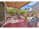 Inviting covered patio with outdoor seating, chandelier, and a built-in grill area at 8953 Belconte Ln, Henderson, NV 89074