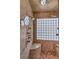 Custom tiled walk-in shower featuring dual shower heads, a built-in bench and unique glass block window for natural light at 8953 Belconte Ln, Henderson, NV 89074