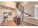 Elegant staircase with wrought iron railing and wood treads in a bright, open foyer at 8953 Belconte Ln, Henderson, NV 89074