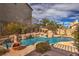 Sparkling swimming pool with rock waterfall features creates a tranquil backyard retreat and privacy at 8953 Belconte Ln, Henderson, NV 89074