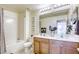 Bathroom with a combination shower and tub, double sinks, and wood cabinets at 909 Cirrus Cloud Ave, Las Vegas, NV 89138