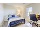 Cozy bedroom with soft carpet, a small work desk, and a wrought iron bed layered with pillows at 909 Cirrus Cloud Ave, Las Vegas, NV 89138