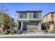 Inviting two-story home features a neutral exterior, attached garage, and a landscaped front yard at 909 Cirrus Cloud Ave, Las Vegas, NV 89138