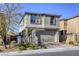 Charming two-story home with a modern stucco exterior and an attached two-car garage at 909 Cirrus Cloud Ave, Las Vegas, NV 89138