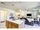 Open-concept living with a kitchen island, barstool seating and stainless appliances at 909 Cirrus Cloud Ave, Las Vegas, NV 89138