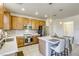 Well-lit kitchen features an island with pendant lighting and stainless steel appliances at 909 Cirrus Cloud Ave, Las Vegas, NV 89138