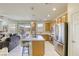Updated kitchen showcases stainless appliances, tile backsplash, island and barstool seating at 909 Cirrus Cloud Ave, Las Vegas, NV 89138