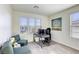 Home office featuring carpeted floors, a work desk, and comfortable teal upholstered arm chairs at 909 Cirrus Cloud Ave, Las Vegas, NV 89138