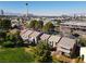 Aerial view of townhomes and community in a vibrant neighborhood with the city skyline in the background at 914 Tam O Shanter, Las Vegas, NV 89109
