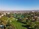 Scenic aerial view of a golf course with a city skyline in the distance and peaceful ponds at 914 Tam O Shanter, Las Vegas, NV 89109
