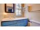 Bathroom showcasing a sink vanity, mirror, and a window at 914 Tam O Shanter, Las Vegas, NV 89109