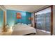 Inviting bedroom with a queen-size bed, accent wall, and decorative screen for added privacy at 914 Tam O Shanter, Las Vegas, NV 89109