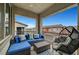Cozy covered balcony with comfortable blue cushioned seating and views of the neighborhood at 965 Nevada State Dr # 38202, Henderson, NV 89002