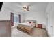 Bedroom featuring neutral carpeting, ceiling fan, minimalist wood bed frame, dresser, and natural light from window at 965 Nevada State Dr # 38202, Henderson, NV 89002