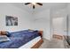 Simple bedroom with a cozy blue comforter, neutral carpet, and a ceiling fan at 965 Nevada State Dr # 38202, Henderson, NV 89002
