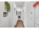 Hallway with a view into a carpeted room, wood-look flooring, and decorative wall hangings at 965 Nevada State Dr # 38202, Henderson, NV 89002