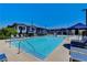Community pool with plenty of chairs and shade for residents to relax and enjoy the sunny weather at 965 Nevada State Dr # 38202, Henderson, NV 89002