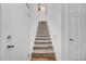 Carpeted staircase with white walls and modern railings leads to the upper level, creating a seamless transition at 965 Nevada State Dr # 38202, Henderson, NV 89002