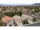 Aerial view showcasing a neighborhood with well-maintained homes, landscaping, and mountain backdrop at 10 Staghorn St, Henderson, NV 89012