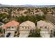 Aerial view of a suburban neighborhood, showcasing similar-style homes and tree coverage at 10 Staghorn St, Henderson, NV 89012