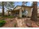 Backyard featuring covered patio, mature landscaping, and stone pathway at 10 Staghorn St, Henderson, NV 89012