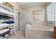 Bright bathroom with tiled shower and soaking tub at 10 Staghorn St, Henderson, NV 89012